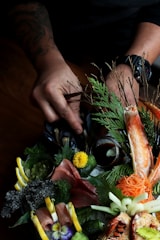 person fixing vegetables with flowers