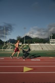 man running while holding stroller