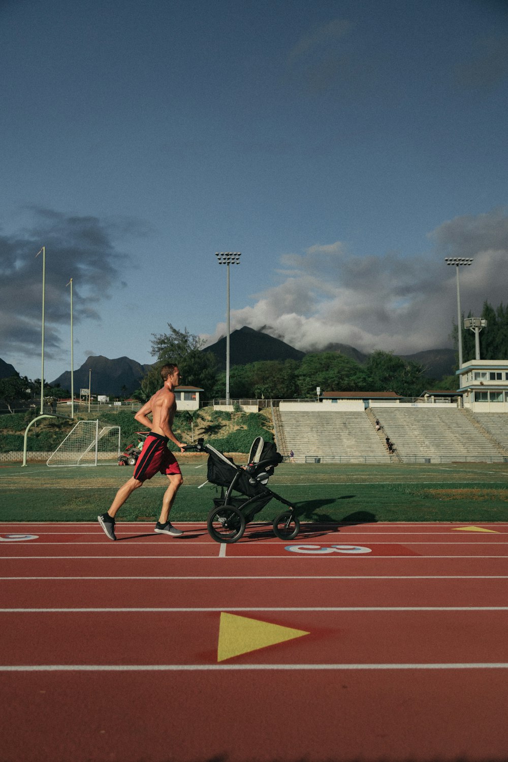 man running while holding stroller