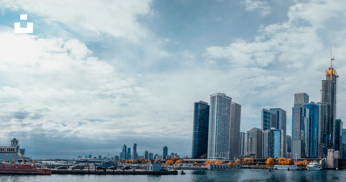 Splashed Buildings High rise buildings near body of water under cloudy sky at daytime ...
