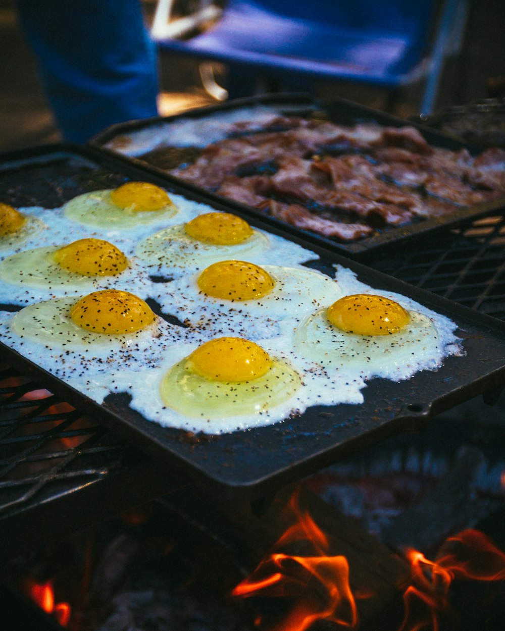 selective focus photography of eight sunny side up fried eggs on pan