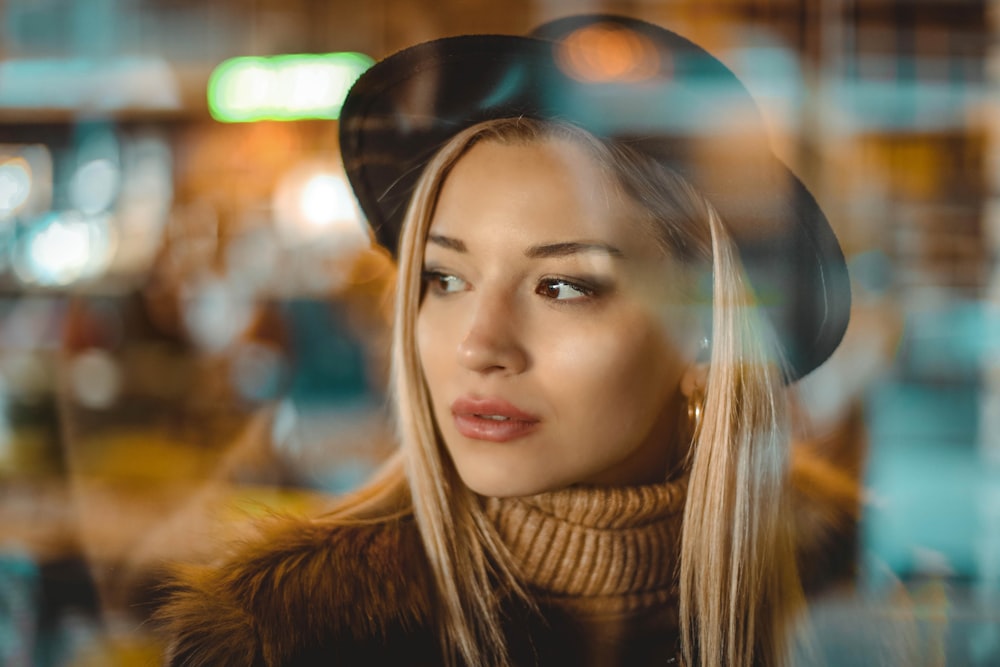 woman wearing hat while looking to her right