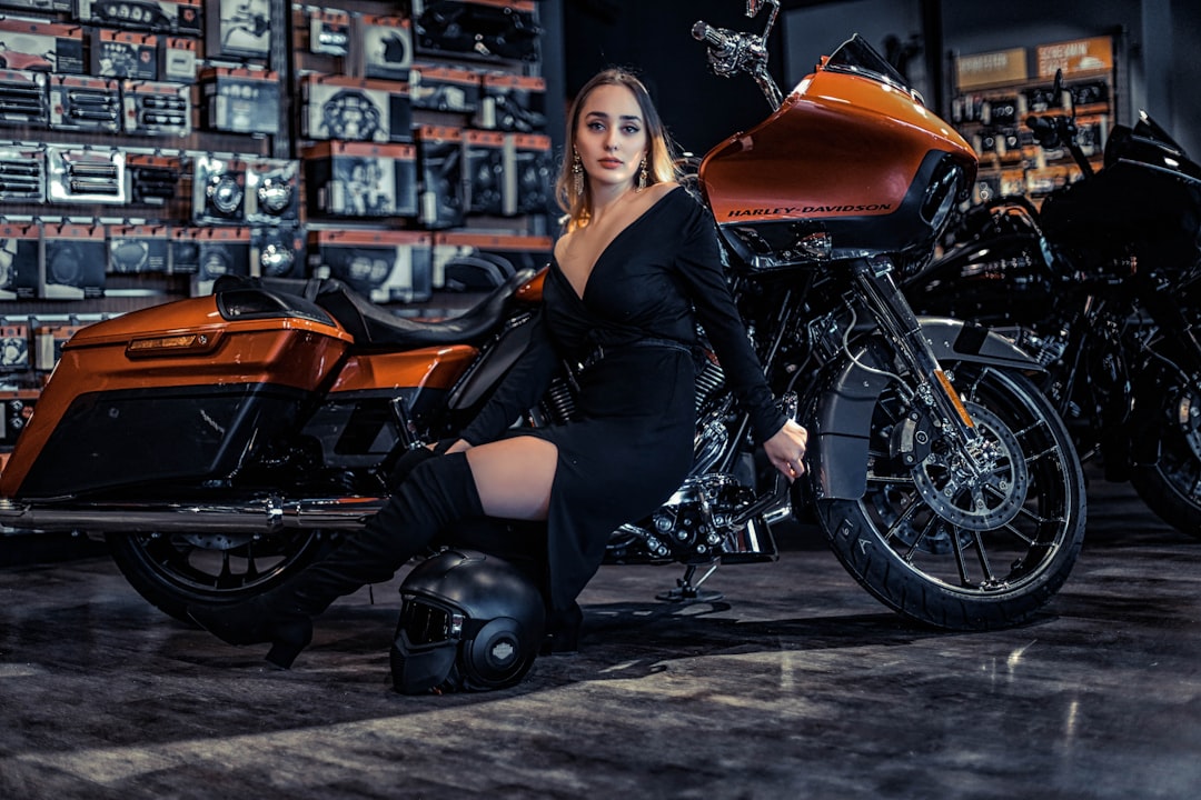 man sitting beside brown motorcycle