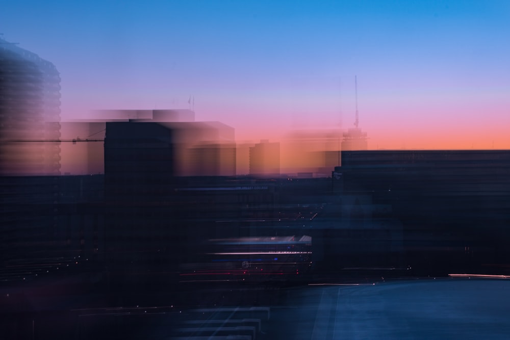 Ein verschwommenes Foto einer Skyline der Stadt bei Sonnenuntergang