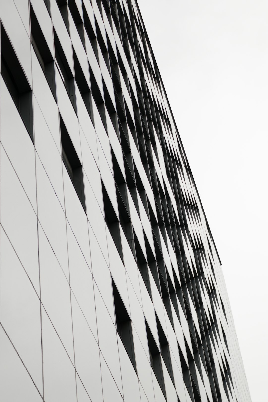 tilt shot of gray and black building under daylight