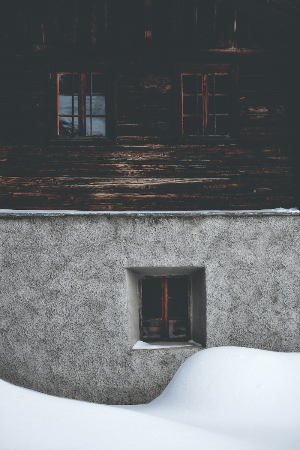 brown wooden building window and grey concrete building window