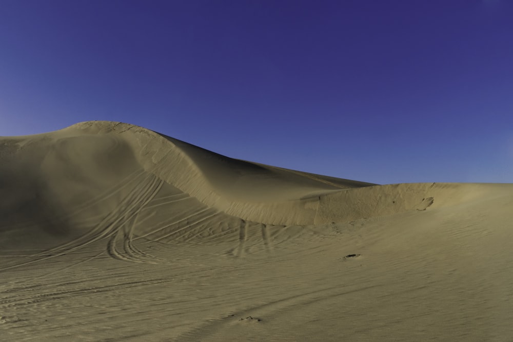 brown sand under blue sky