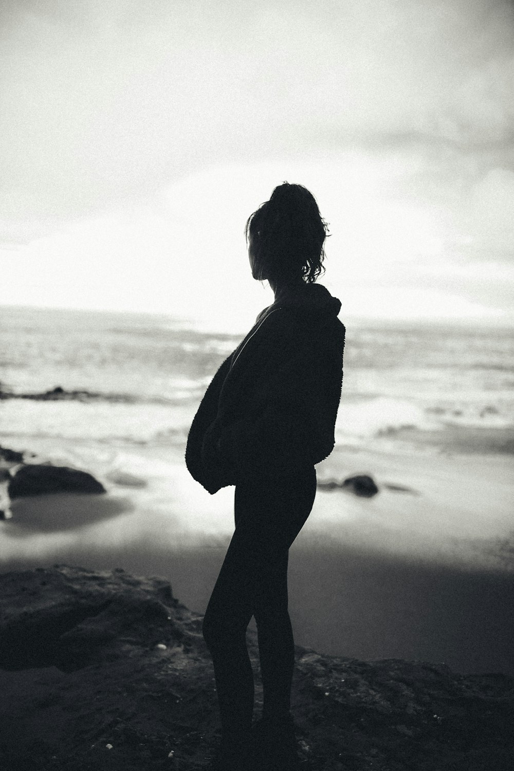 silhouette of woman standing near sea