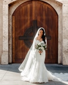 woman wearing wedding dress holding bouquet of flowers