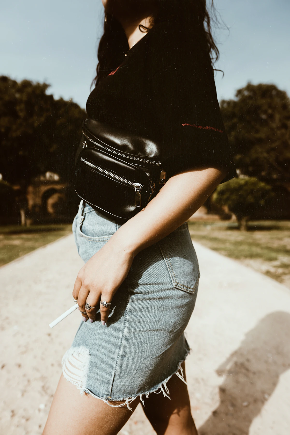 Woman wearing a brown crossbody bag with denim clothing