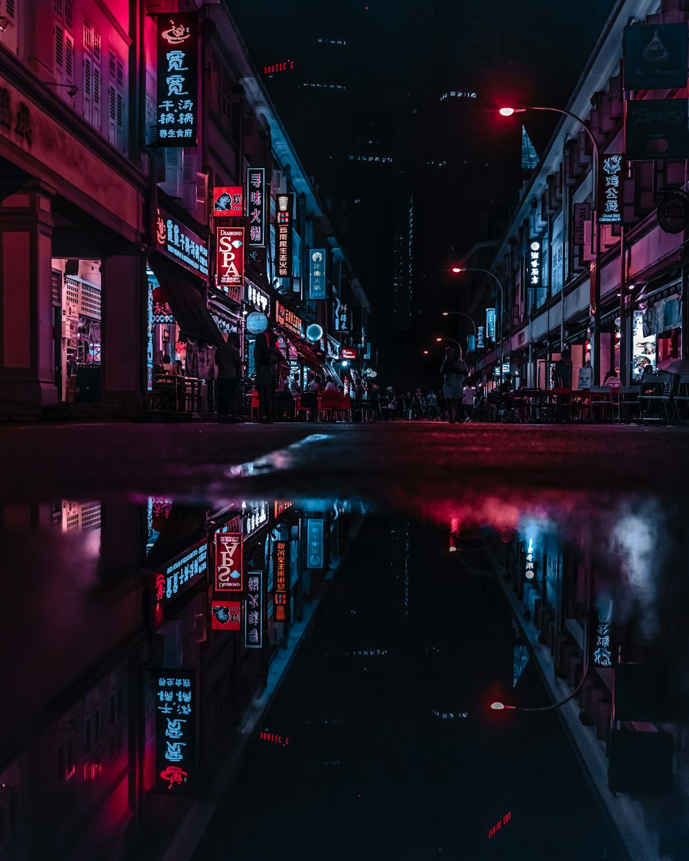 wet street in between building at night