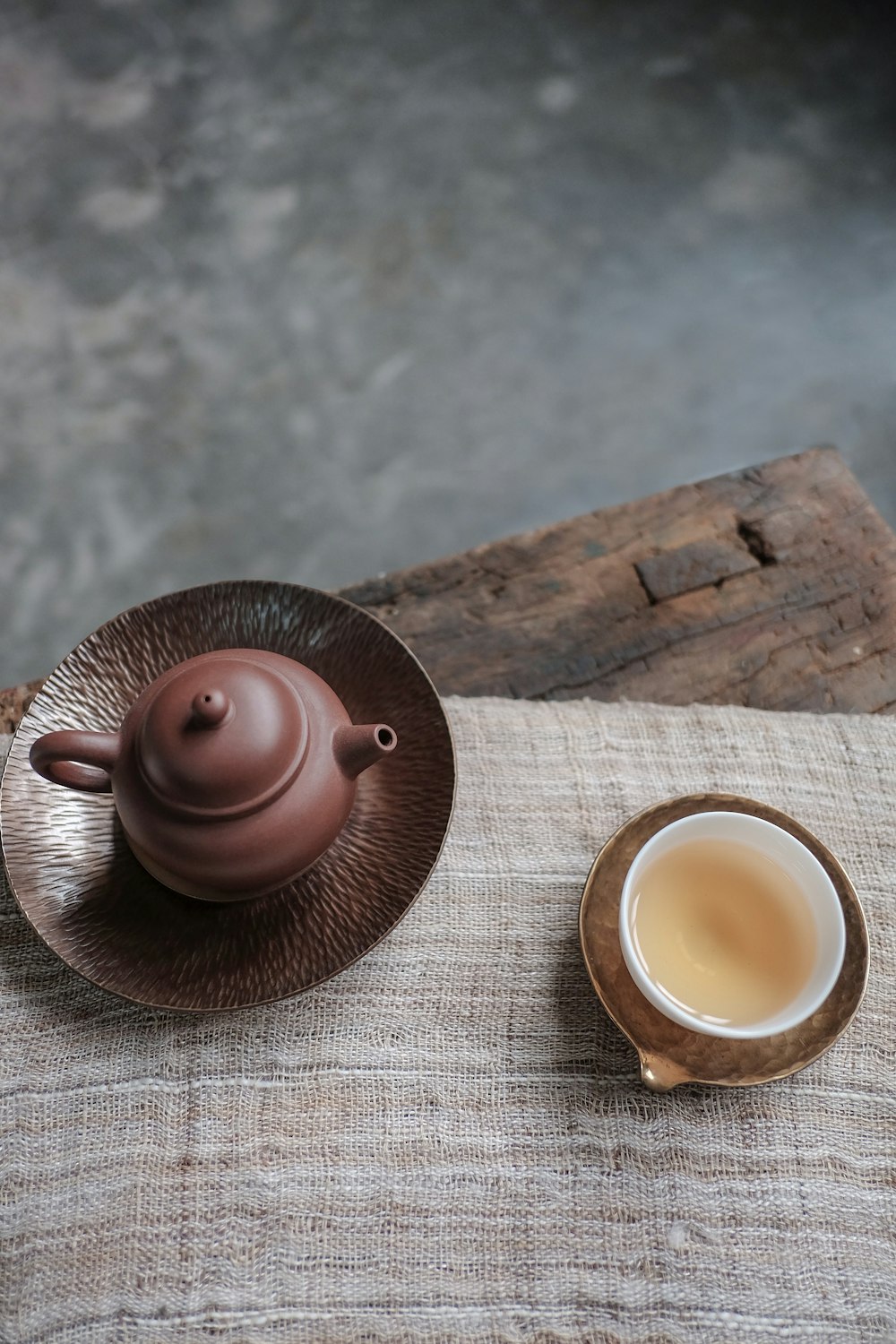 brown kettle and white cup on table