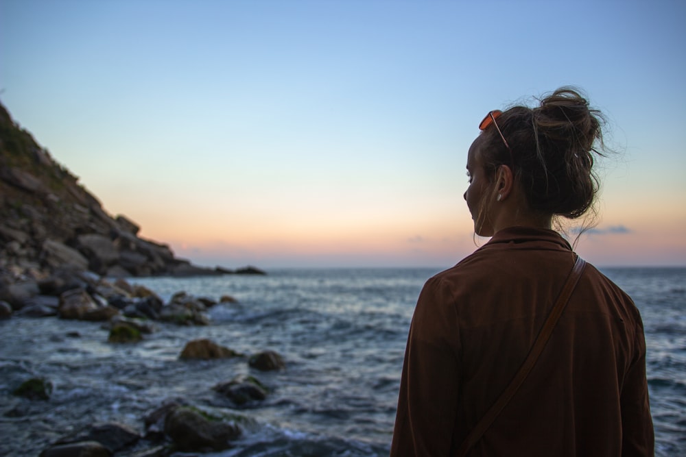 woman standing near body of water