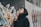 woman wearing black drawstring hoodie near concrete wall