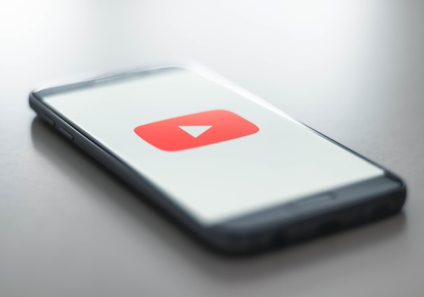 a close up of a cell phone with a youtube logo on it
