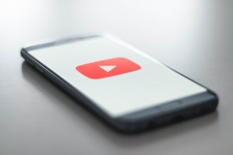 YouTube logo on a cell phone lying on a table