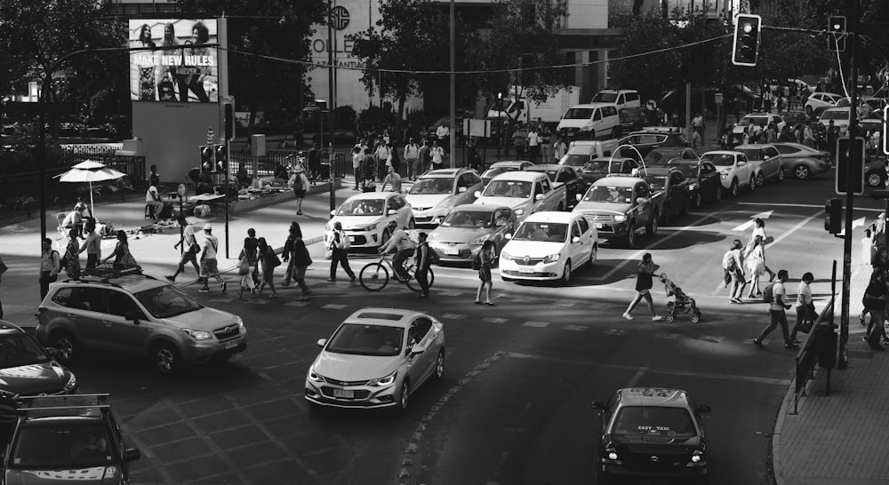grayscale photography of people crossing on street