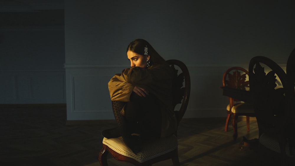 woman sitting on chair inside room