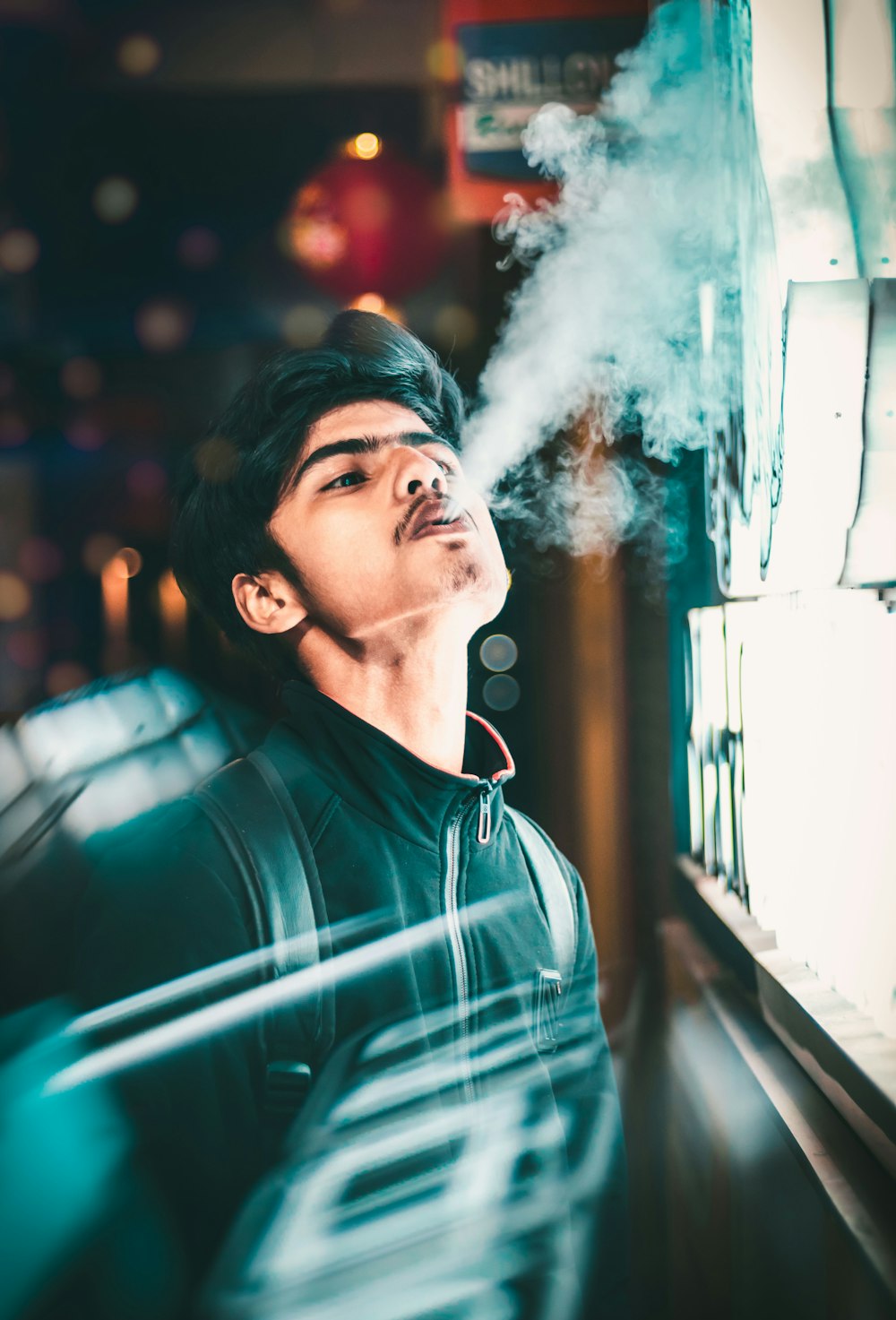man blowing smoke