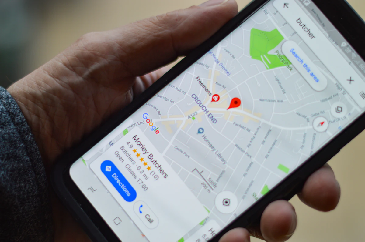Person using Google Maps on a smartphone to search for a nearby local business