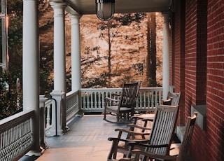 empty rocking chairs by porch