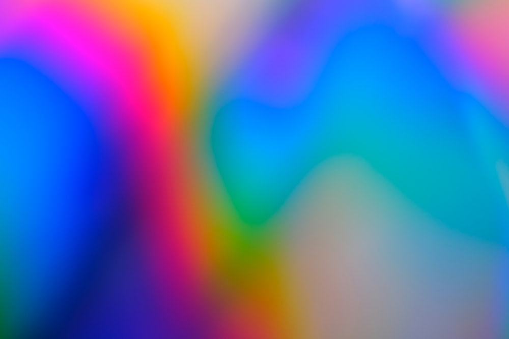 a blurry image of a rainbow colored background