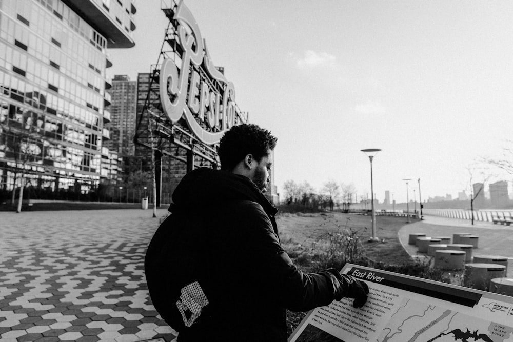 greyscale photo of man wearing jacket