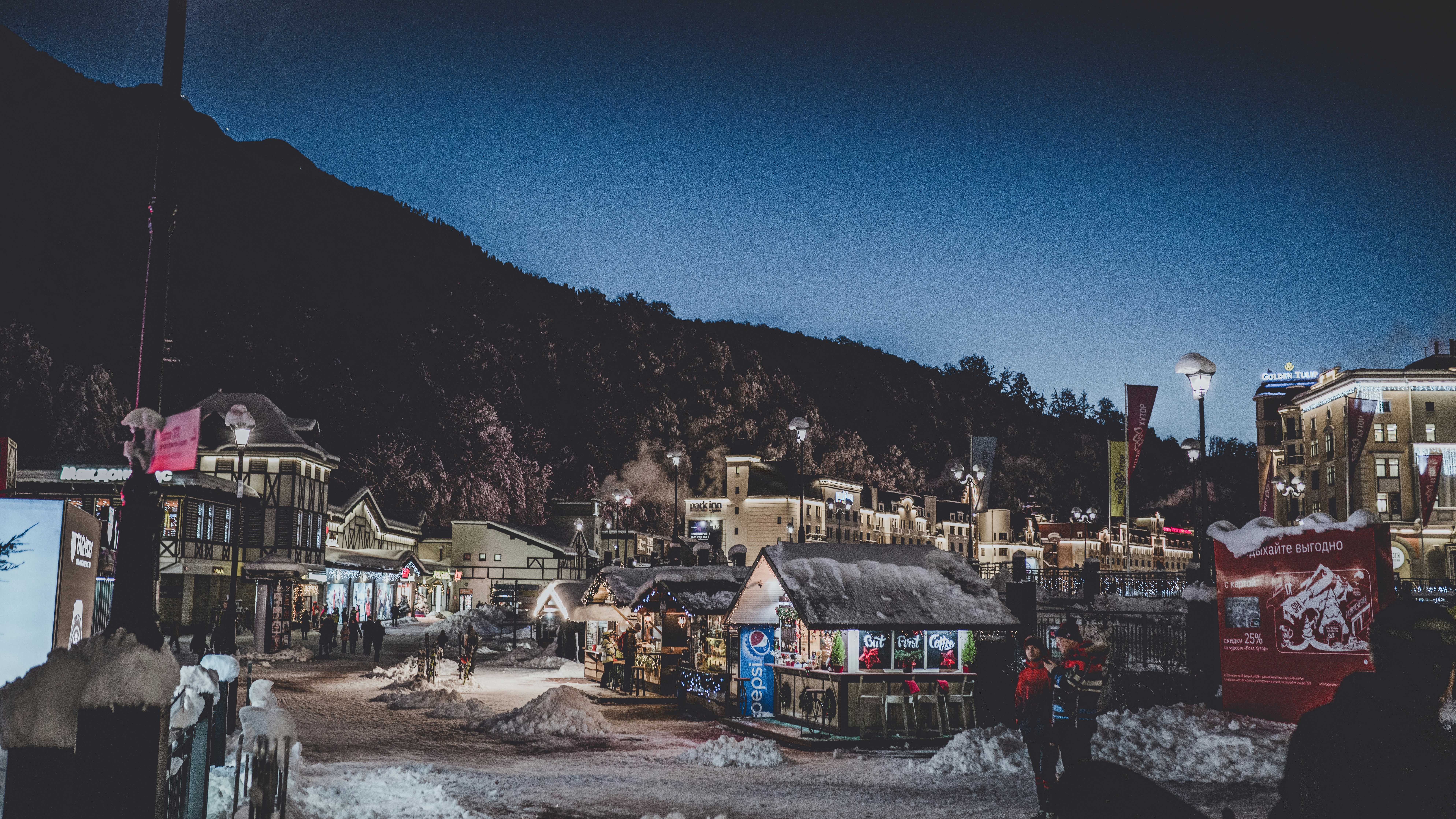 assorted-color buildings near mountain during nighttime
