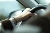 person holding steering wheel