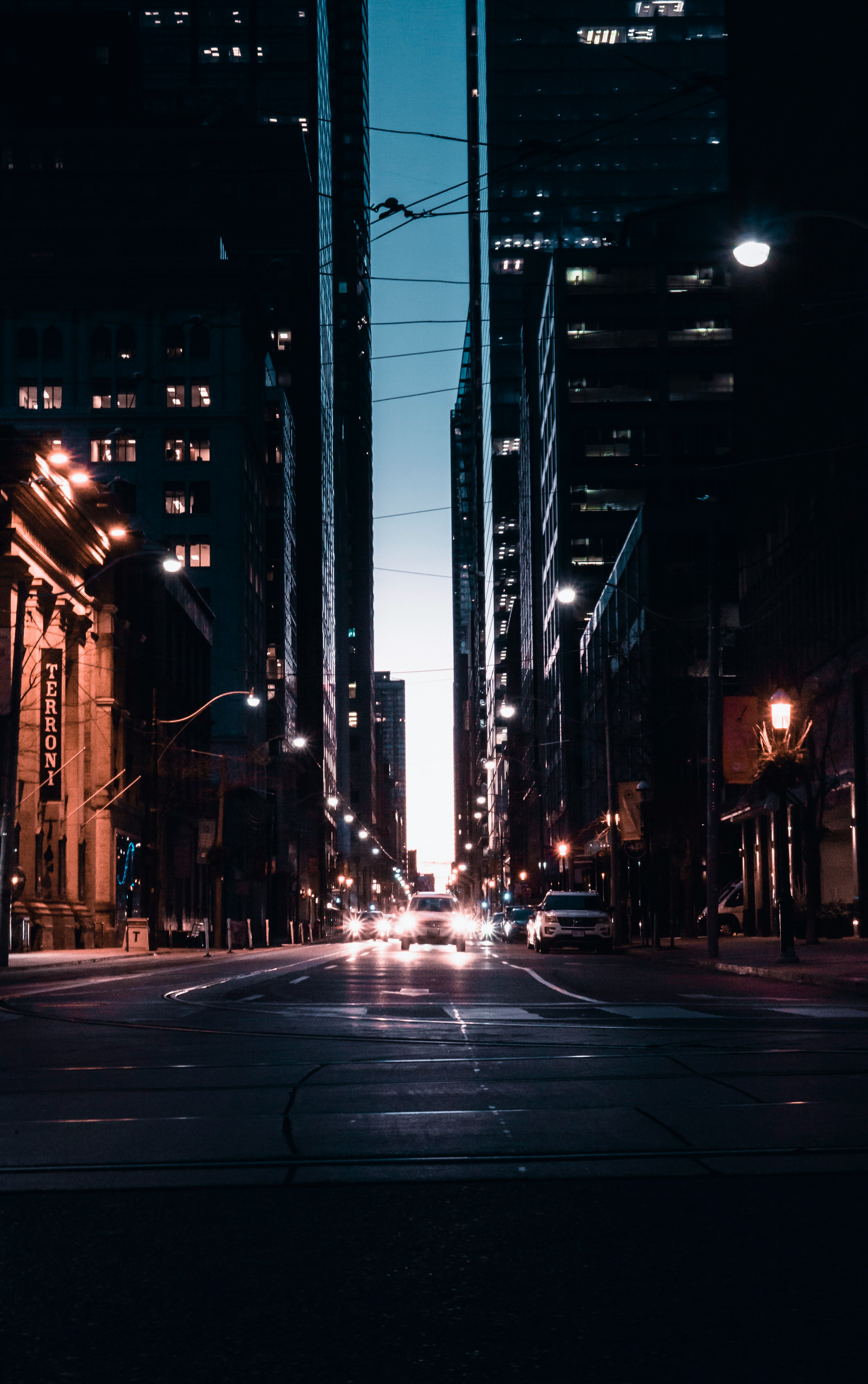 cars with headlights on traveling on street