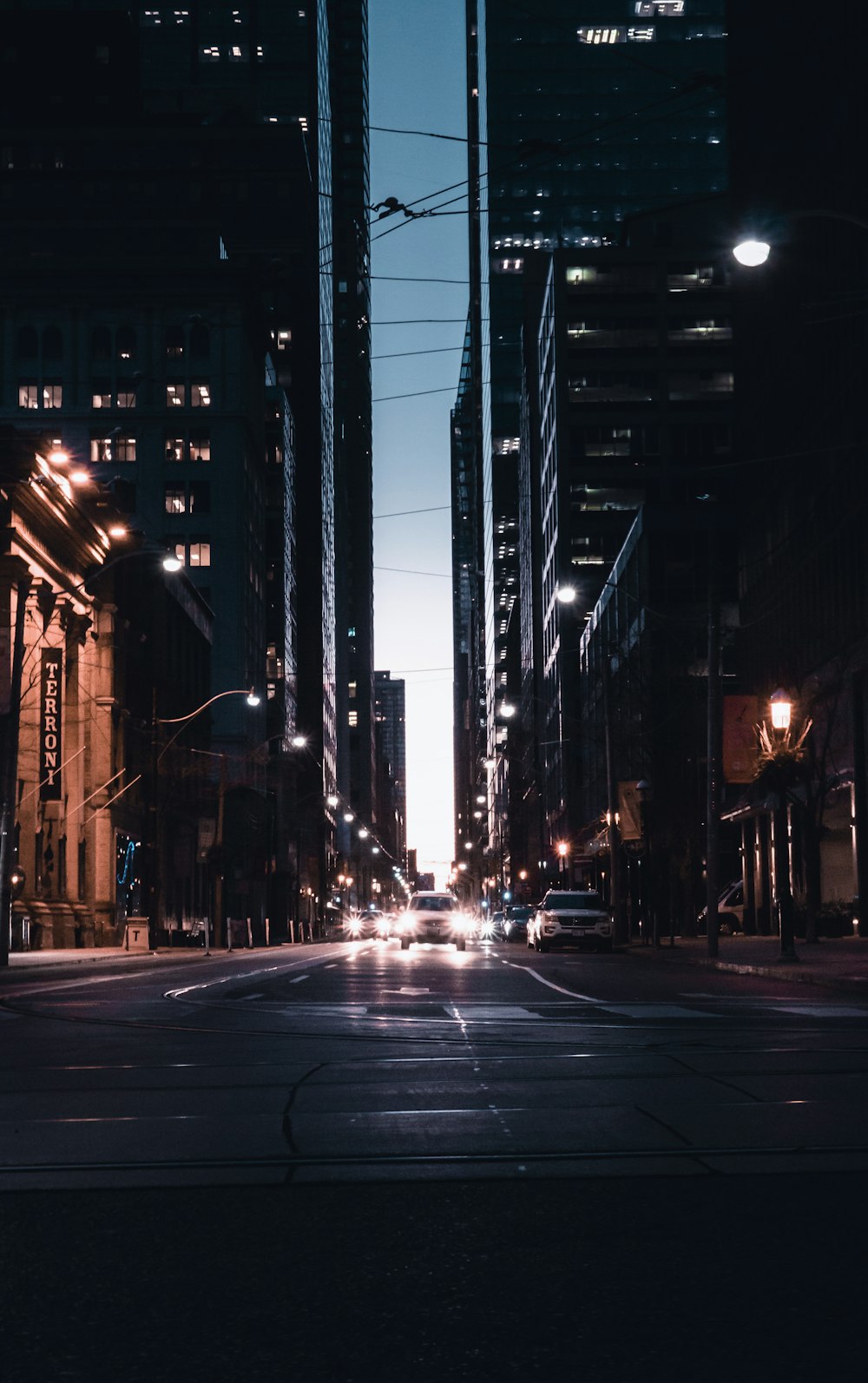 cars with headlights on traveling on street