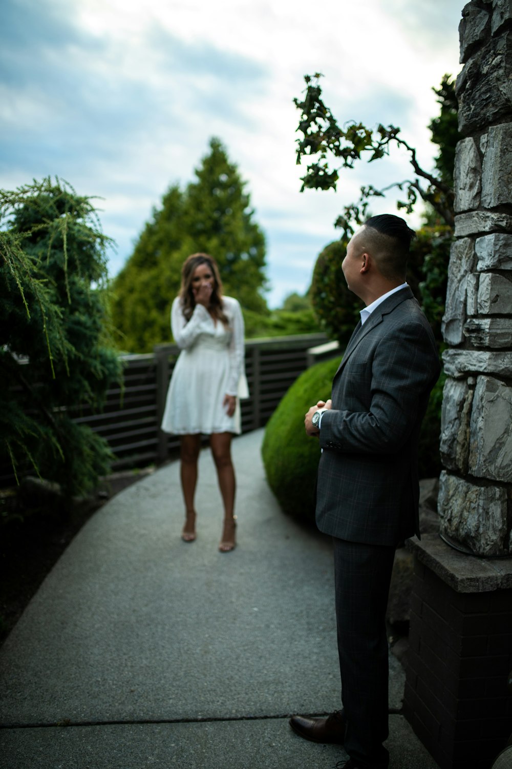 selective focus photography of man standing in front on pile of stone