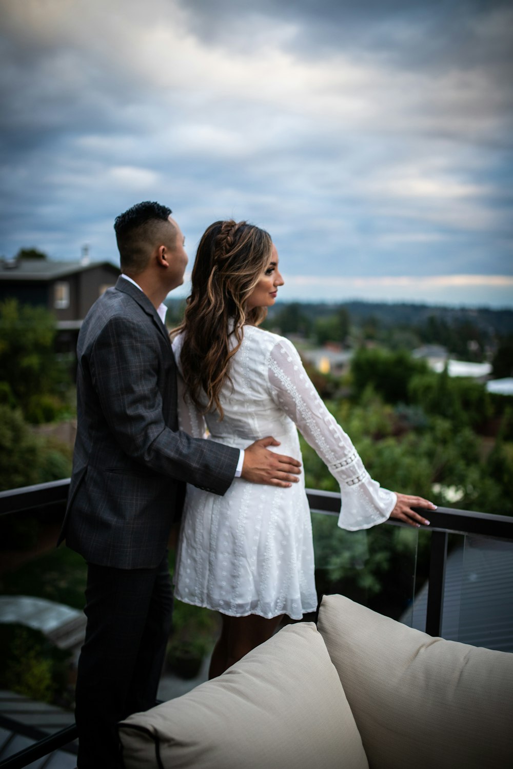 man holding hips of woman under cloud sky during daytime