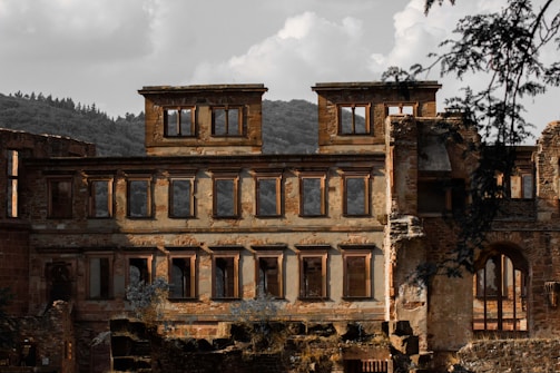 Historic Rockfort Hall exterior showing the roof damage under a cloudy sky.