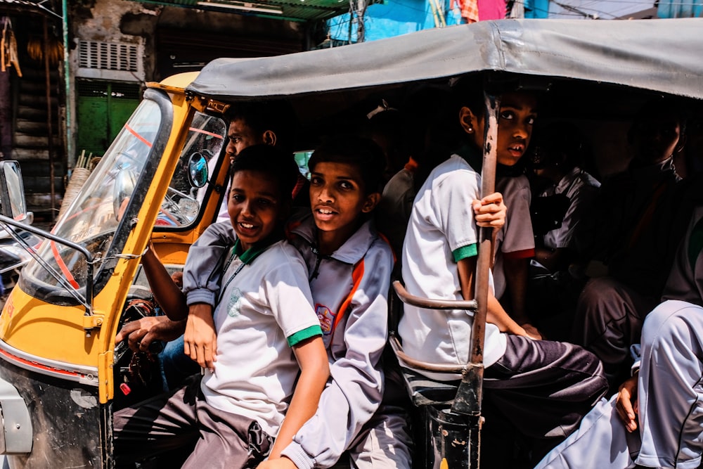 boys riding auto-rickshaw