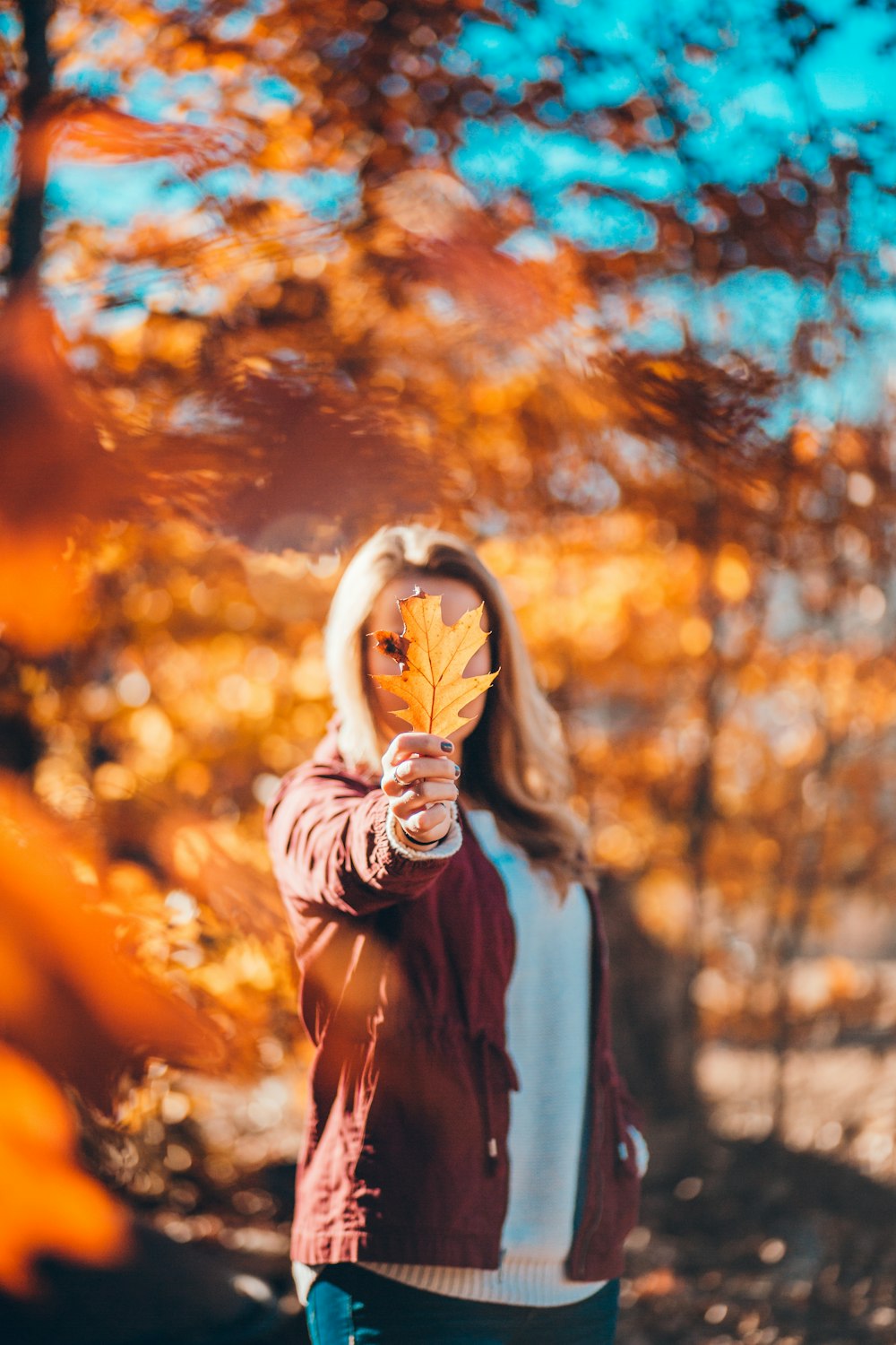 woman holding yellow leaf