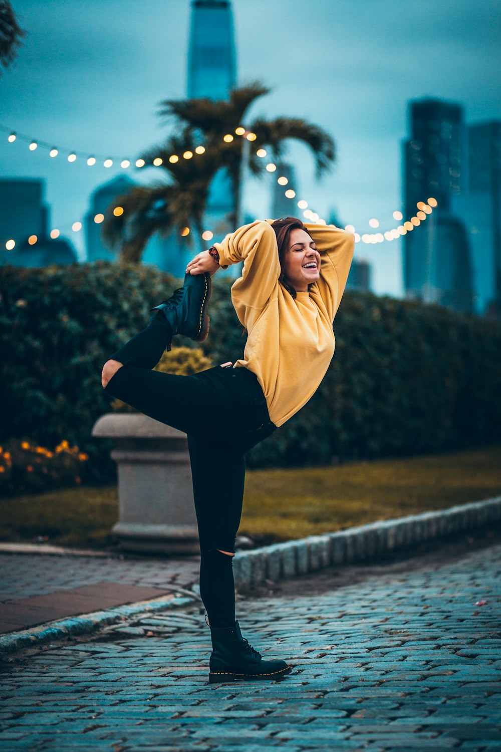 woman in yellow long-sleeved shirt and black jeans