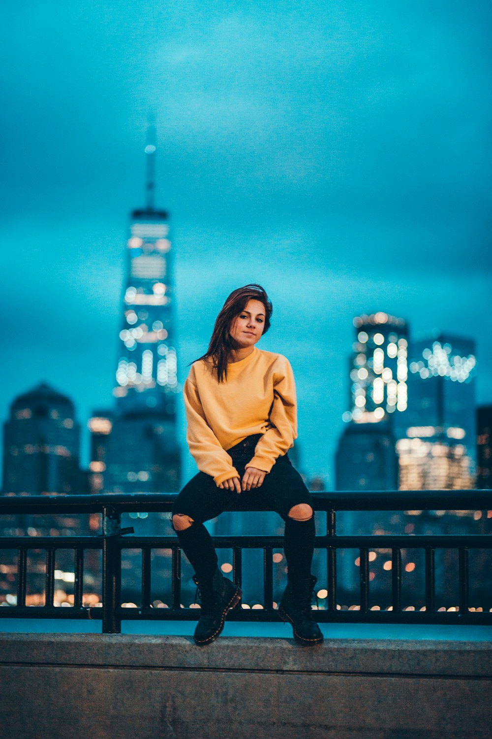 woman in yellow long-sleeved shirt and black jeans