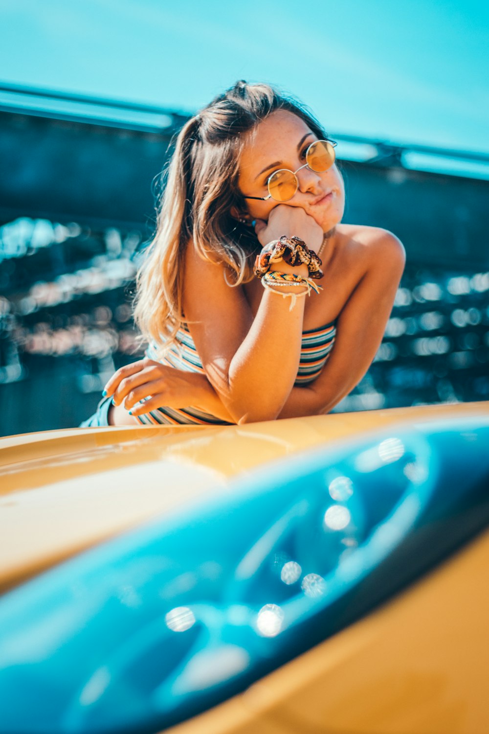 woman leaning on car hood