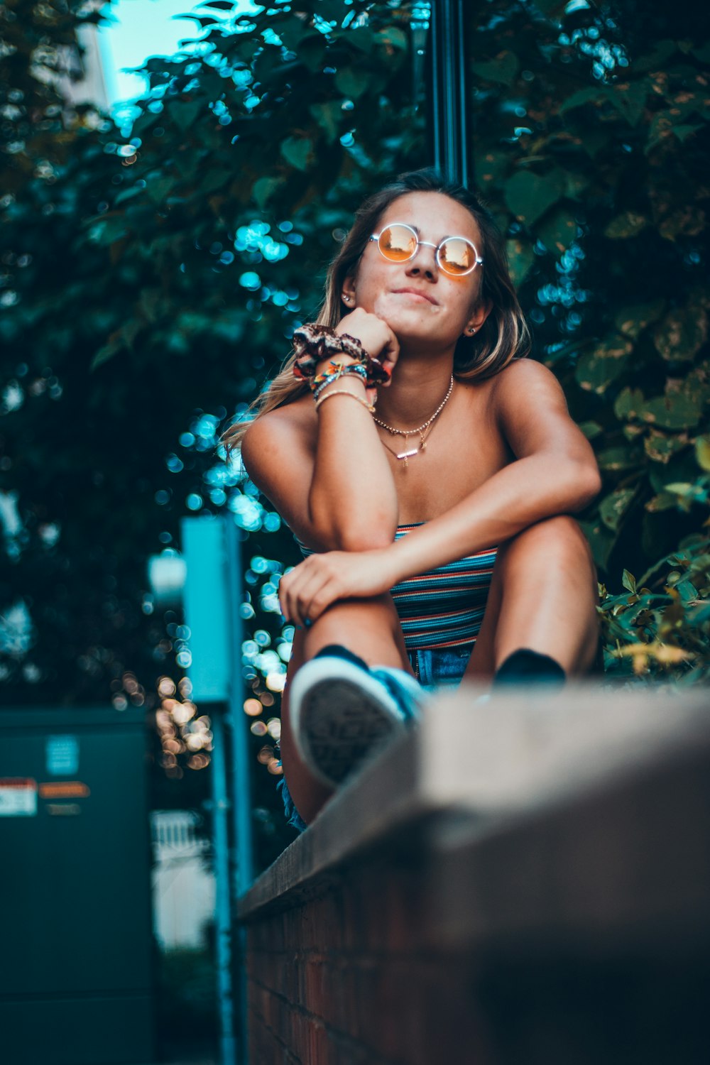 woman sitting on concrete street edge