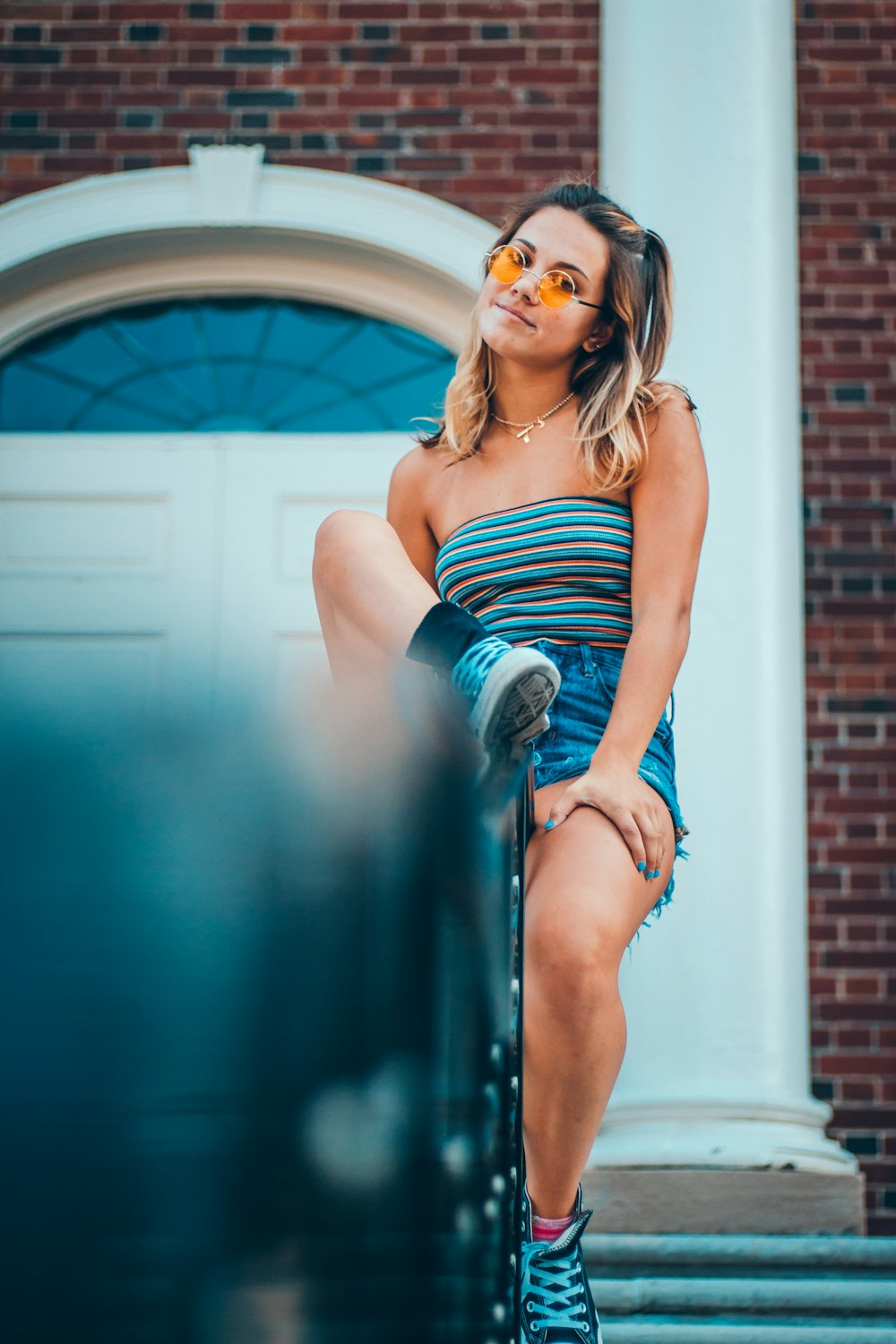 woman sitting near white wooden door