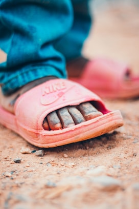 shallow focus photo of red Nike slides