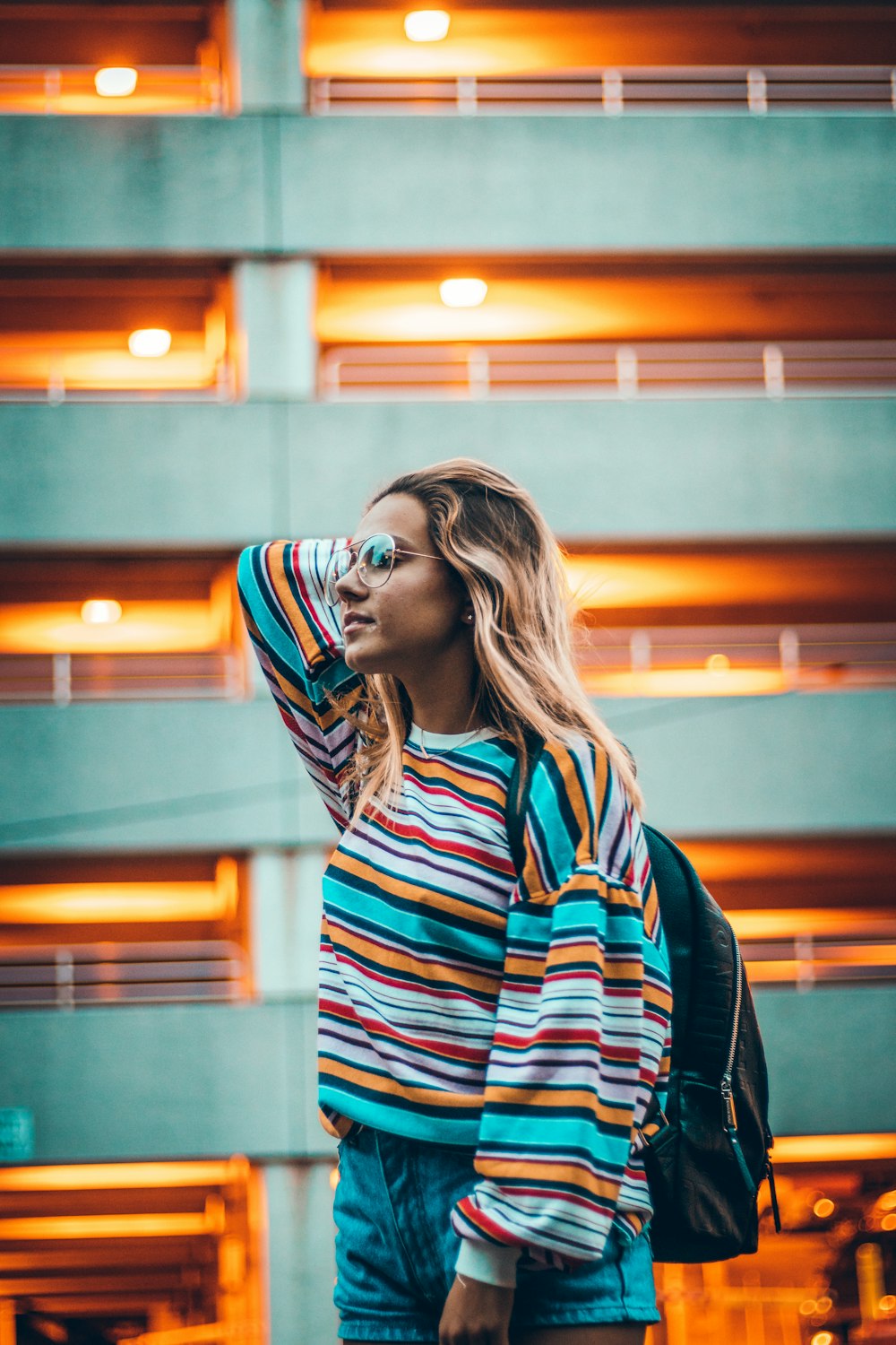 woman standing near gray concrete building