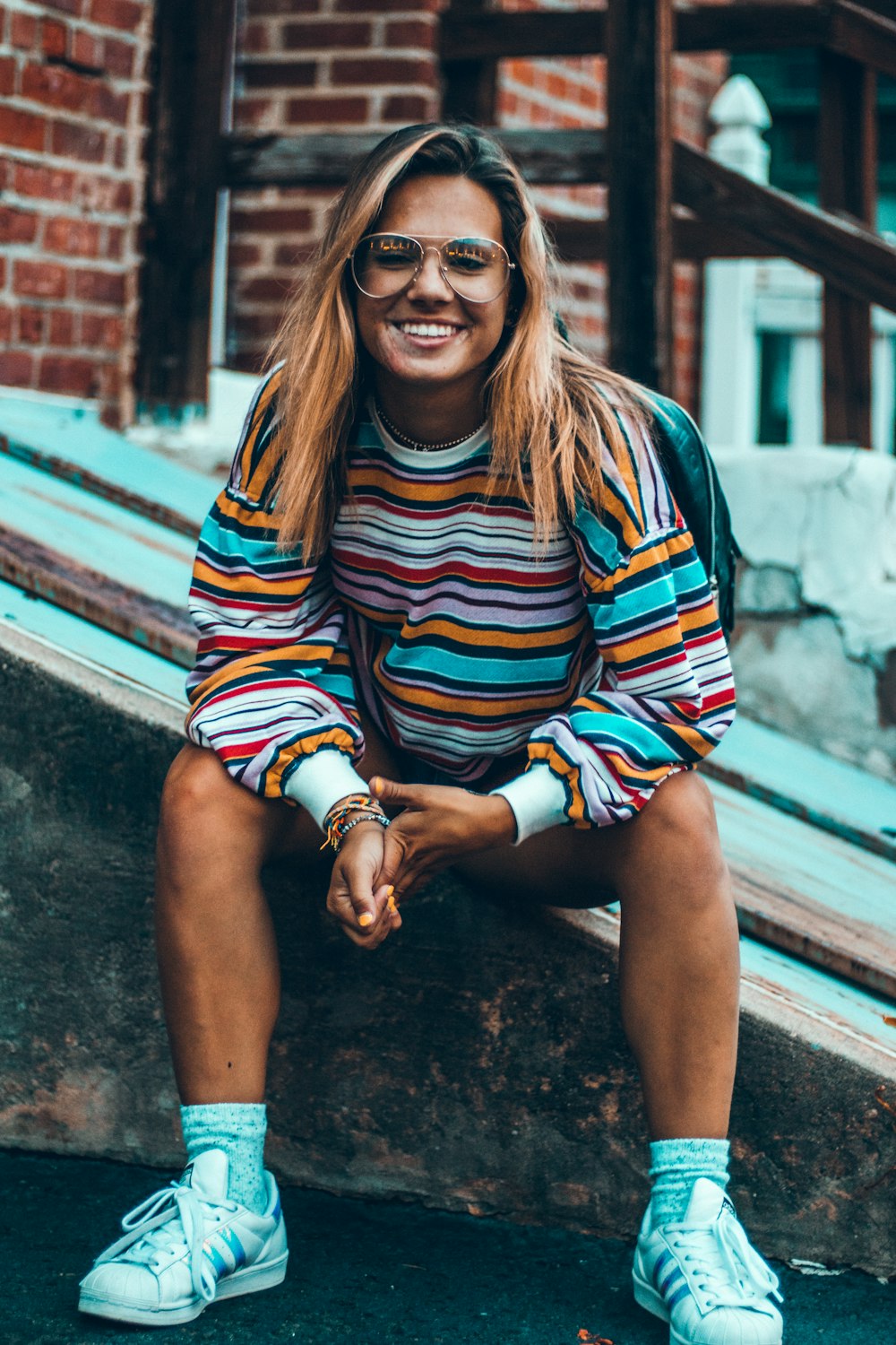 woman sitting while smiling during daytime