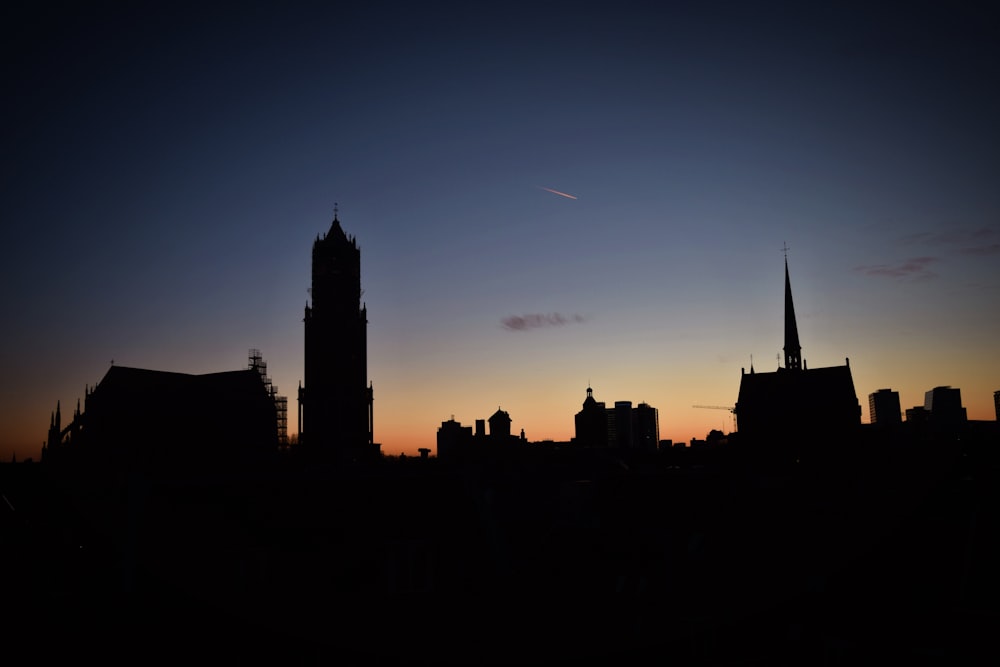 silhouette of buildings under blue sky