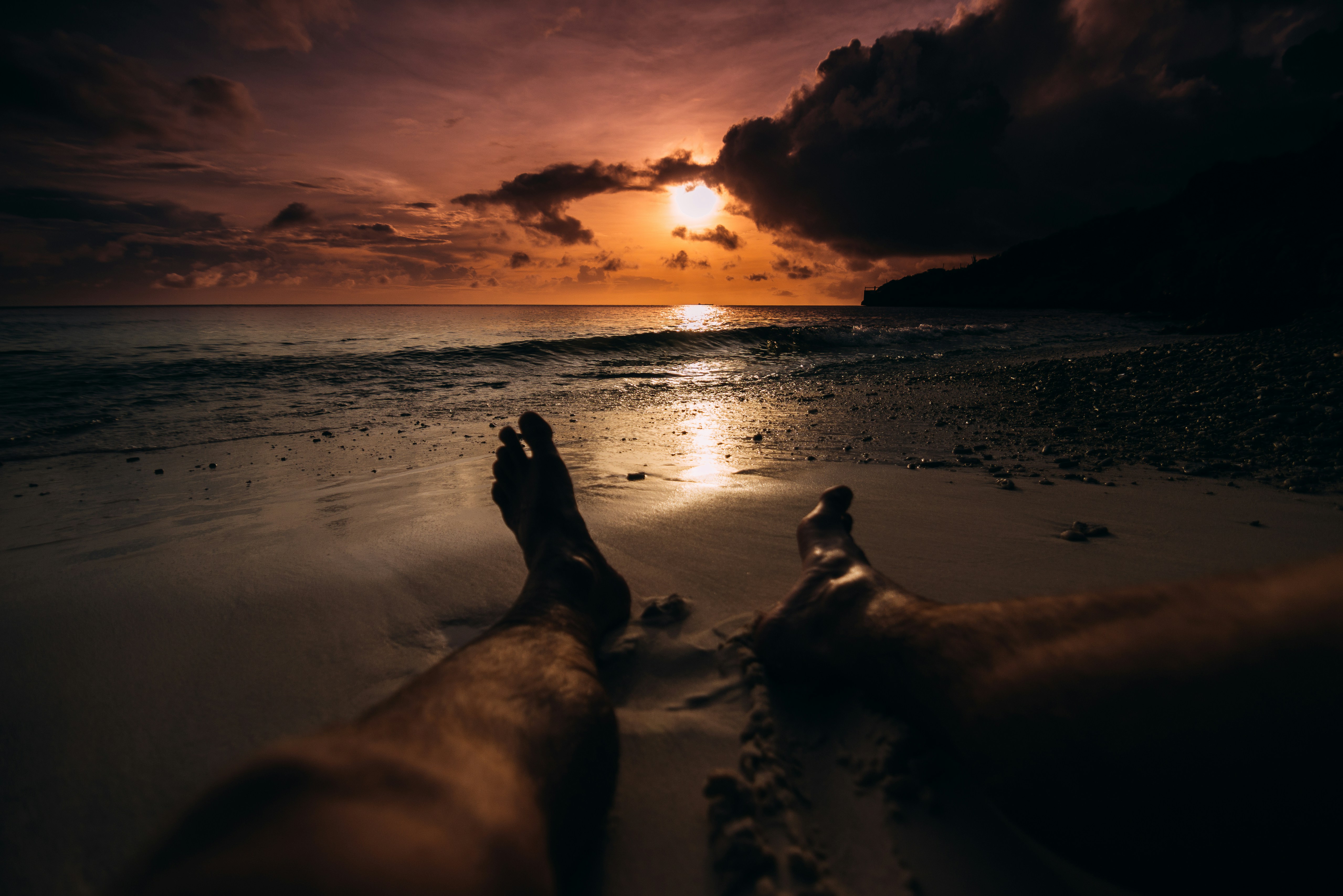 person lying on beach sand