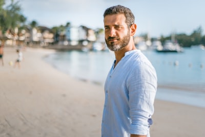 man standing on beach during daytime mature zoom background