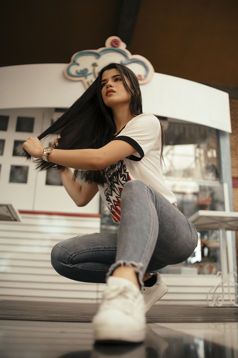 woman in white t-shirt with blue denim jeans with sneakers