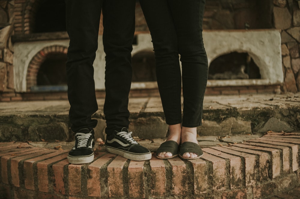 two persons standing on brown concrete floor