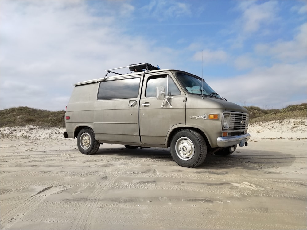 gray minivan under white clouds and blue sky